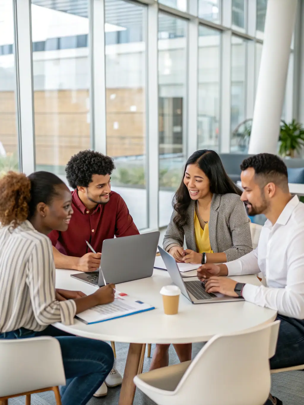 A diverse group of professionals collaborating in a modern office setting, brainstorming ideas and strategies during a business training session, emphasizing teamwork and innovation.