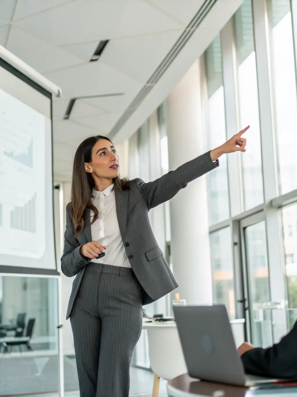 A confident speaker presenting to an audience, showcasing public speaking and presentation skills learned through the business training program, highlighting effective communication.